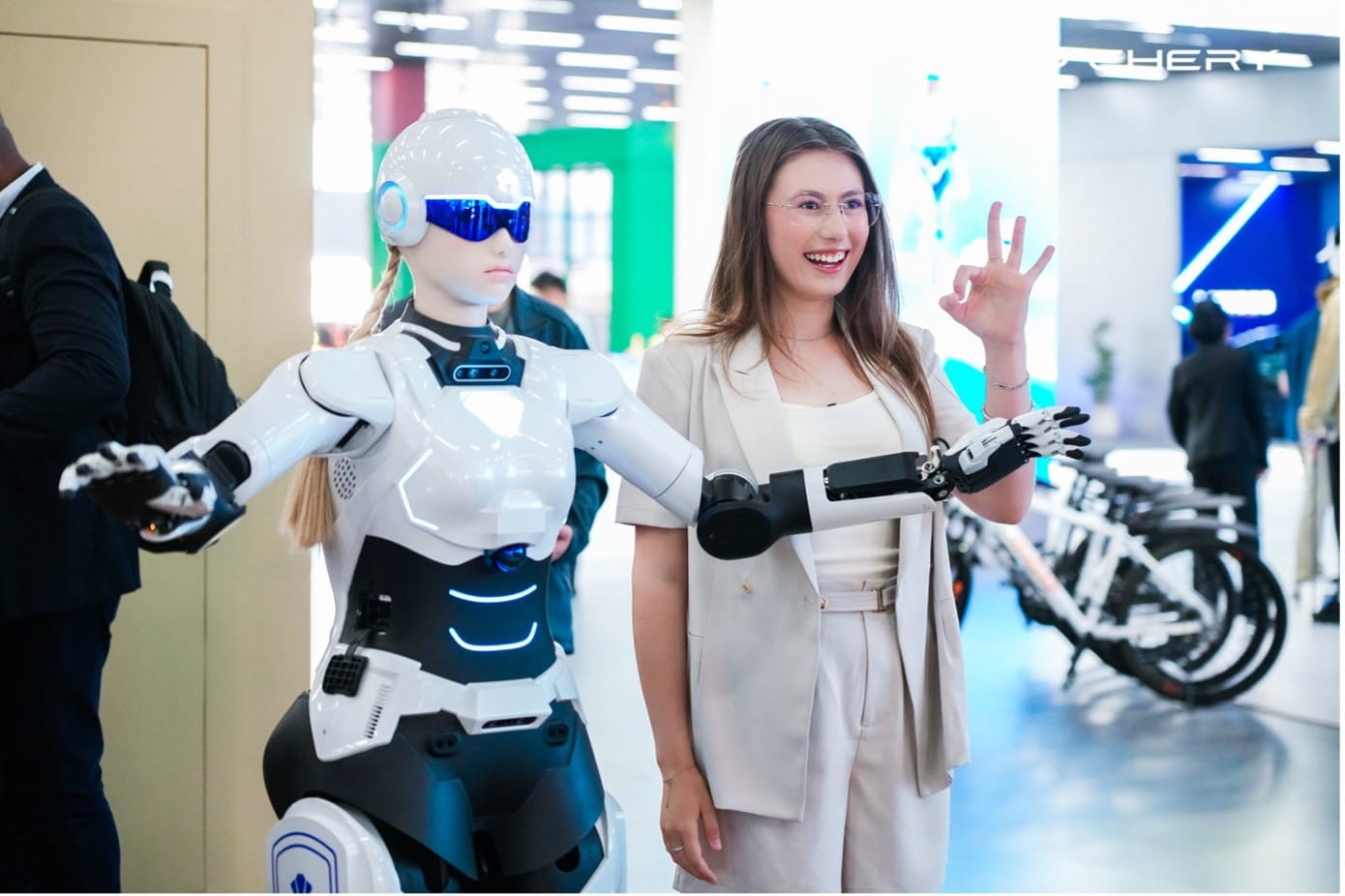 Partners posing with the AiMOGA Robotics in the exhibition area